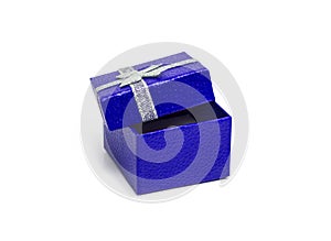 Open dark blue gift box with silver ribbon isolated on white background