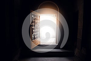 open dark church door and light