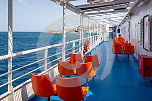 Open deck with chairs on a ferry on a sunny day, Cyclades, Greece