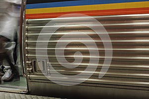 Open door on subway train with feet