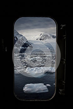 An open door to Antarctica, icebergs and mountains