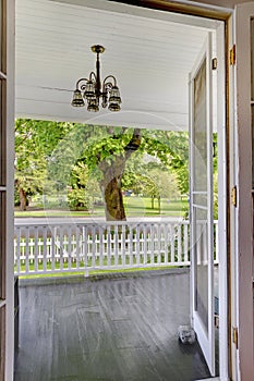 Open door to the front porch with view of the park.