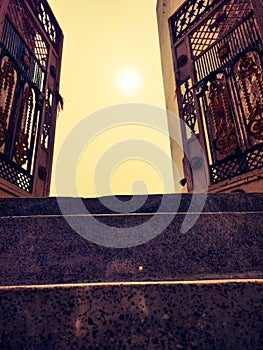 Open door with view of sky and sun