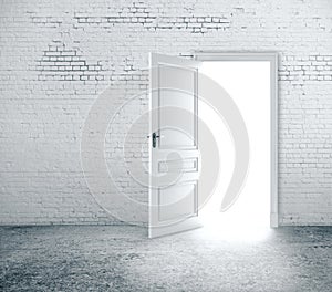 Open door in white brick wall