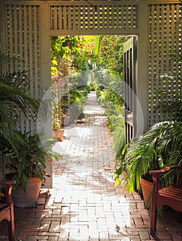 An open doorway leads to a tropical path in Key West Florida