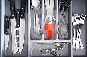 Open drawer with different utensils and cutlery in kitchen, above view