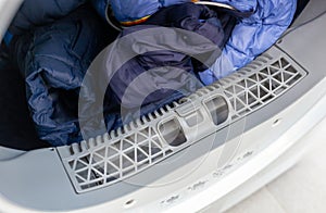Open dryer with lint trap and clean laundry