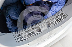 Open dryer with lint trap and clean laundry photo