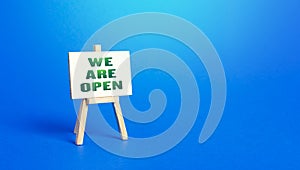 We Are Open easel sign. Exit from severe quarantine conditions, economic and business recovery. Return to normal life. Adaptation