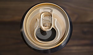 An open and empty aluminum can with drinks.