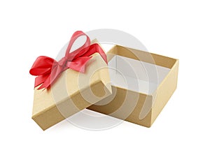 open empty beige gold gift box with red ribbon bow wrapped around lid isolated on white background