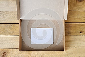 Open empty box with white card inside.