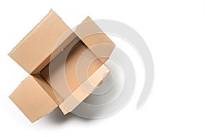 Open empty cardbord box package for delivering and transport on a white background, high angel view from above, copy space