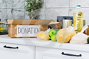 Open empty donation box with food near it in kitchen