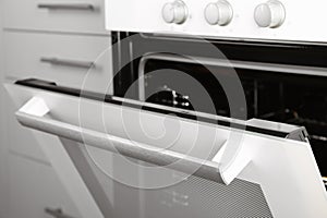 Open empty electric oven in kitchen