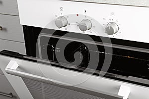 Open empty electric oven in kitchen