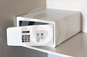 Open empty electronic hotel safe on a shelf