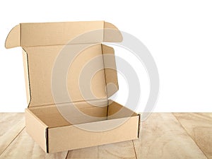 open empty flap brown beige carton box on wooden table counter isolated on white background