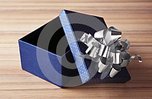 Open empty gift box with bow on table