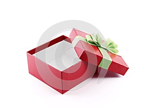 open and empty gift box wrapped in red color paper with grid pattern with lime green ribbon and folded bow isolated on white