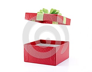 open and empty gift box wrapped in red paper with grid pattern with lime green ribbon and folded bow isolated on white background