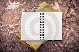 Open empty notebook on wooden background