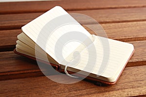 Open empty notebook on a wooden table