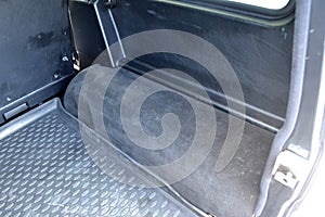 Open empty side part of trunk arch of a car suv close-up after washing and vacuuming with a clean mat of special black material