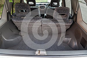 Open empty trunk of a car suv close-up after washing and vacuuming with a clean mat of special black material ready for loading