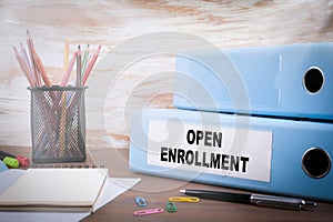 Open Enrollment. Office Binder on Wooden Desk