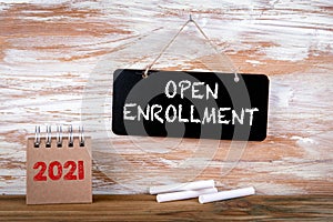 OPEN ENROLLMENT. Small chalk board and white chalk