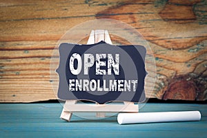 Open Enrollment. small wooden board with chalk on the table