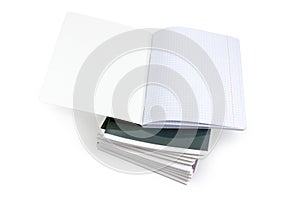 Open exercise book on a stack of other exercise books