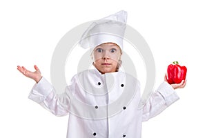 Open-eyed chef girl in a cap cook uniform with both arms up, holding red bell pepper in one hand. Human emotions, facial