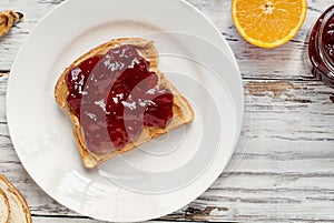 Open Face Peanut Butter and Strawberry Jelly Sandwich with Fruit