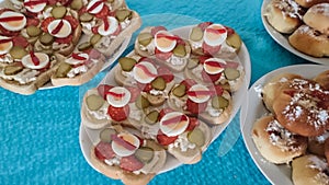 Open-face sandwiches as a gastronomic background. Colorful texture from slices of french bread with ham, cheese, hard-boiled eggs,