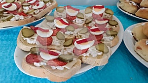 Open-face sandwiches as a gastronomic background. Colorful texture from slices of french bread with ham, cheese, hard-boiled eggs,