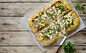 Open face vegetable pie with cabbage, potatoes, feta and greens close up