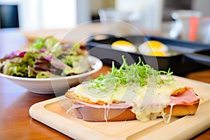 open-faced croque monsieur before top bread added, ingredients in focus