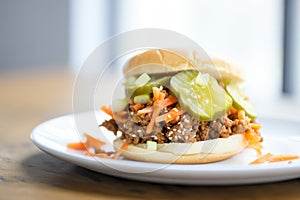 open-faced sloppy joe on a sesame seed bun