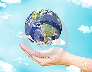Open female hand with floating world globe and cloud with light