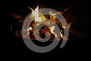 Open fire on campground black background