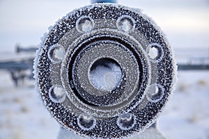 Open flange valve flange, background of round shut-off valves, covered with hoarfrost