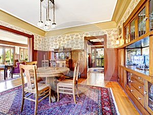 Open floor plan antique dining area with wooden panel trim
