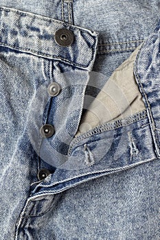 Open fly on a pair of blue jeans.