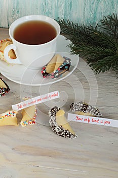 Open fortune cookie happy new year and tea