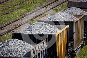 Open freight railway wagons loaded with crushed stone. Freight transportation of bulk building materials by rail. Shot