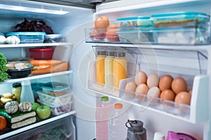 open fridge door with full of food and ingredient