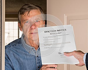 Man in suit giving eviction notice to renter or tenant of home photo