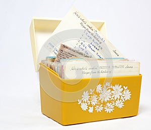 Open front view of vintage 1970s yellow recipe box with recipe cards